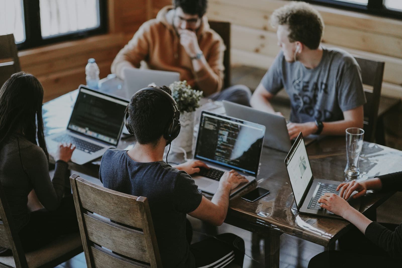 An engineering team working through a problem together at one table